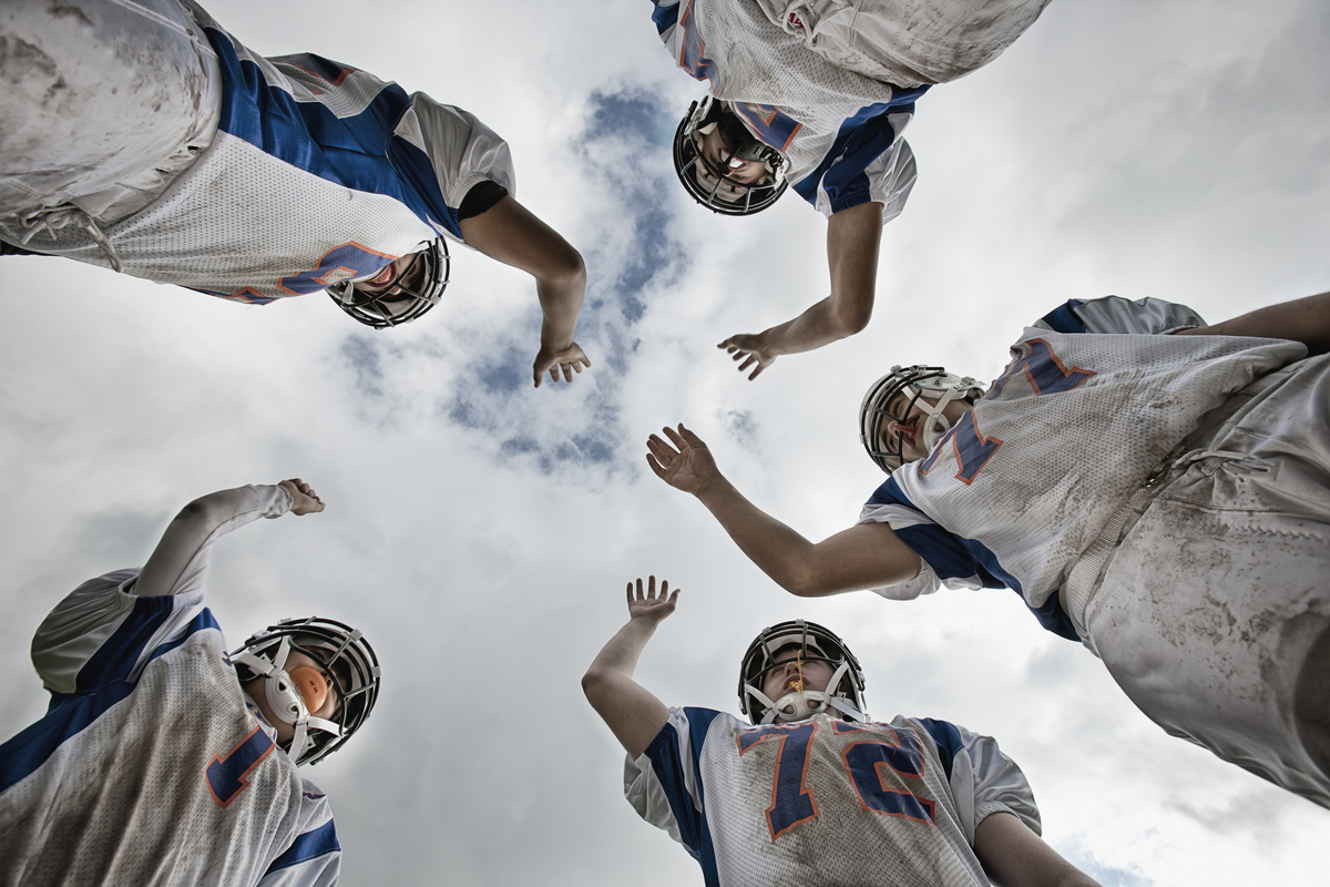 a group of football players arms