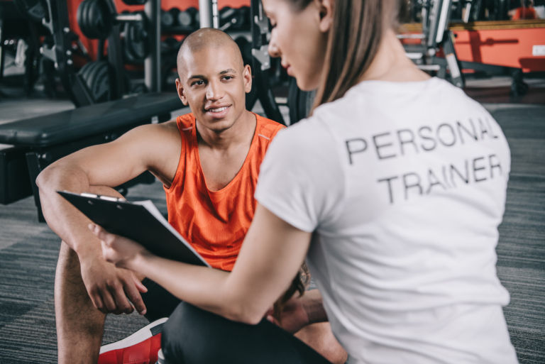 personal trainer showing clipboa