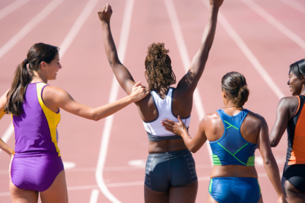 young female runner cheering her