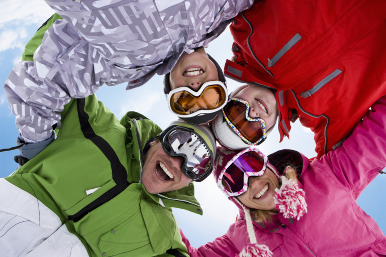 smiling family hugging in circle