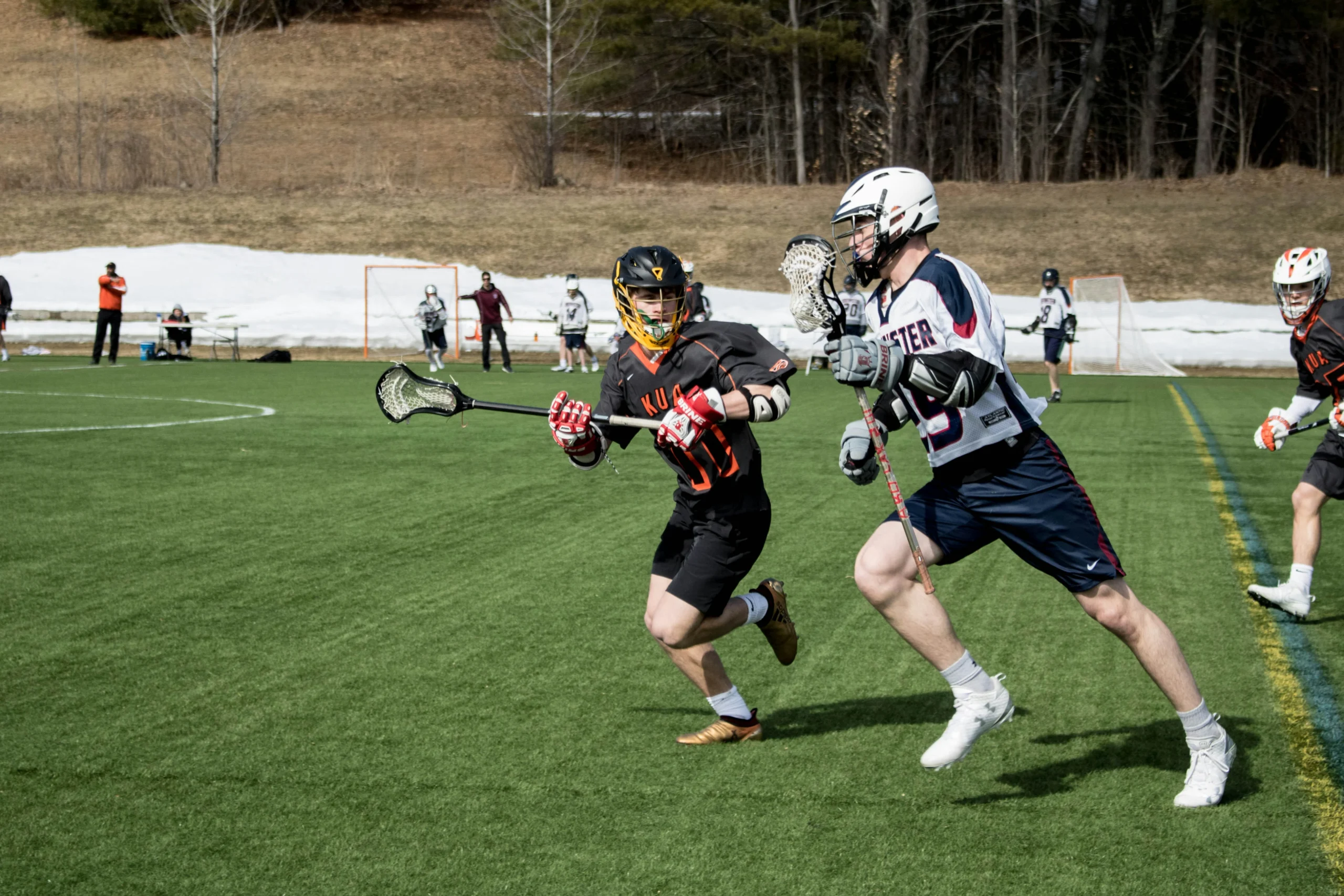 Two players competing in lacrosse match