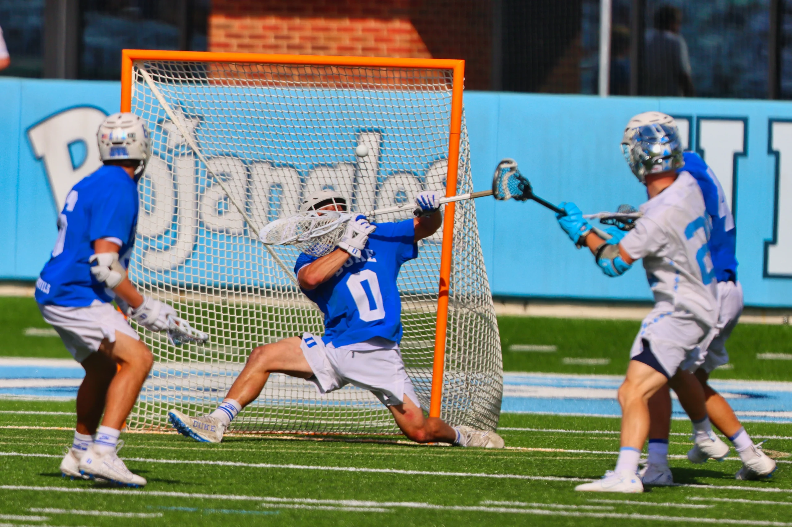 Two players facing off in lacrosse